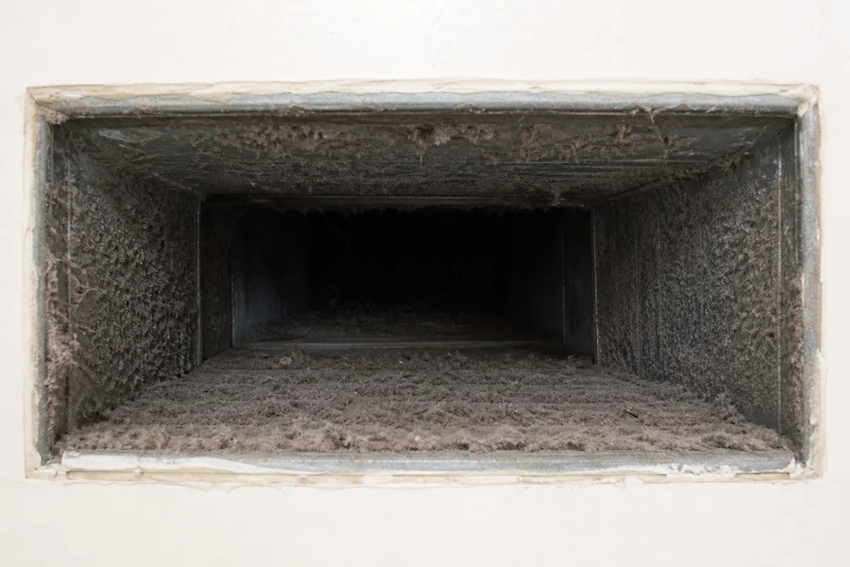 Air Duct Before Professional Cleaning Dust and debris inside an air duct before cleaning